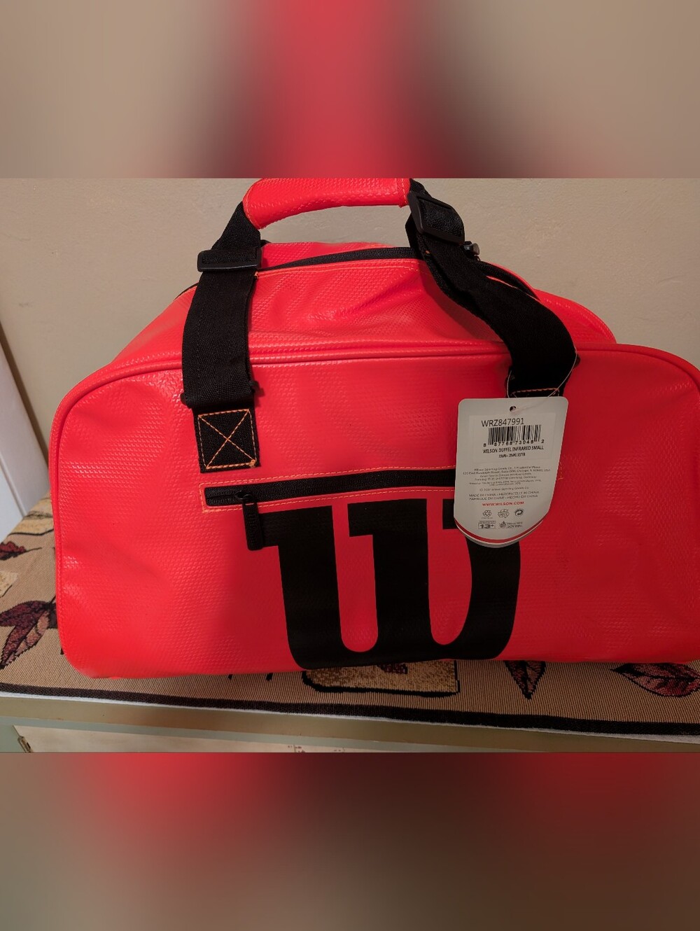 Wilson Neon Red Duffel Bag with Black Logo and Straps